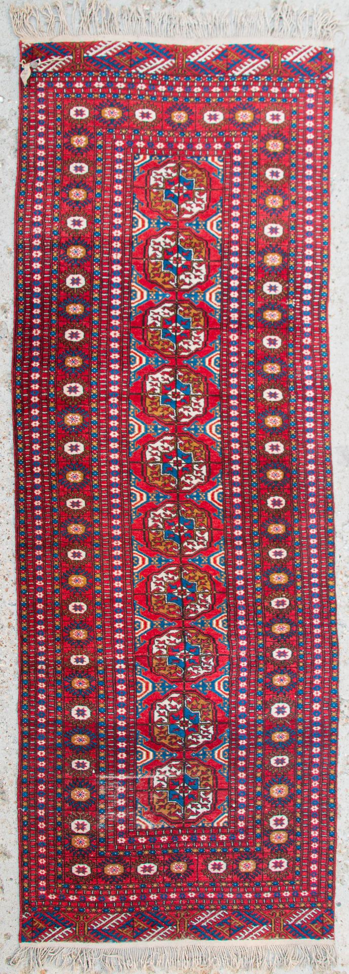 An Oriental hand-made carpet runner. Bokhara / Turkaman. (98 x 278 cm)