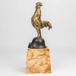 A bronze statue of a rooster standing on a German helmet and marked H. Calot. The first half of the