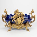 A large bowl decorated with putti and a bird in Louis XV style. 19th century. (28 x 47 x 28 cm)