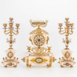 A 3 piece garniture clock made of alabaster mounted with bronze and hand-painted plaques. (11 x 28,5