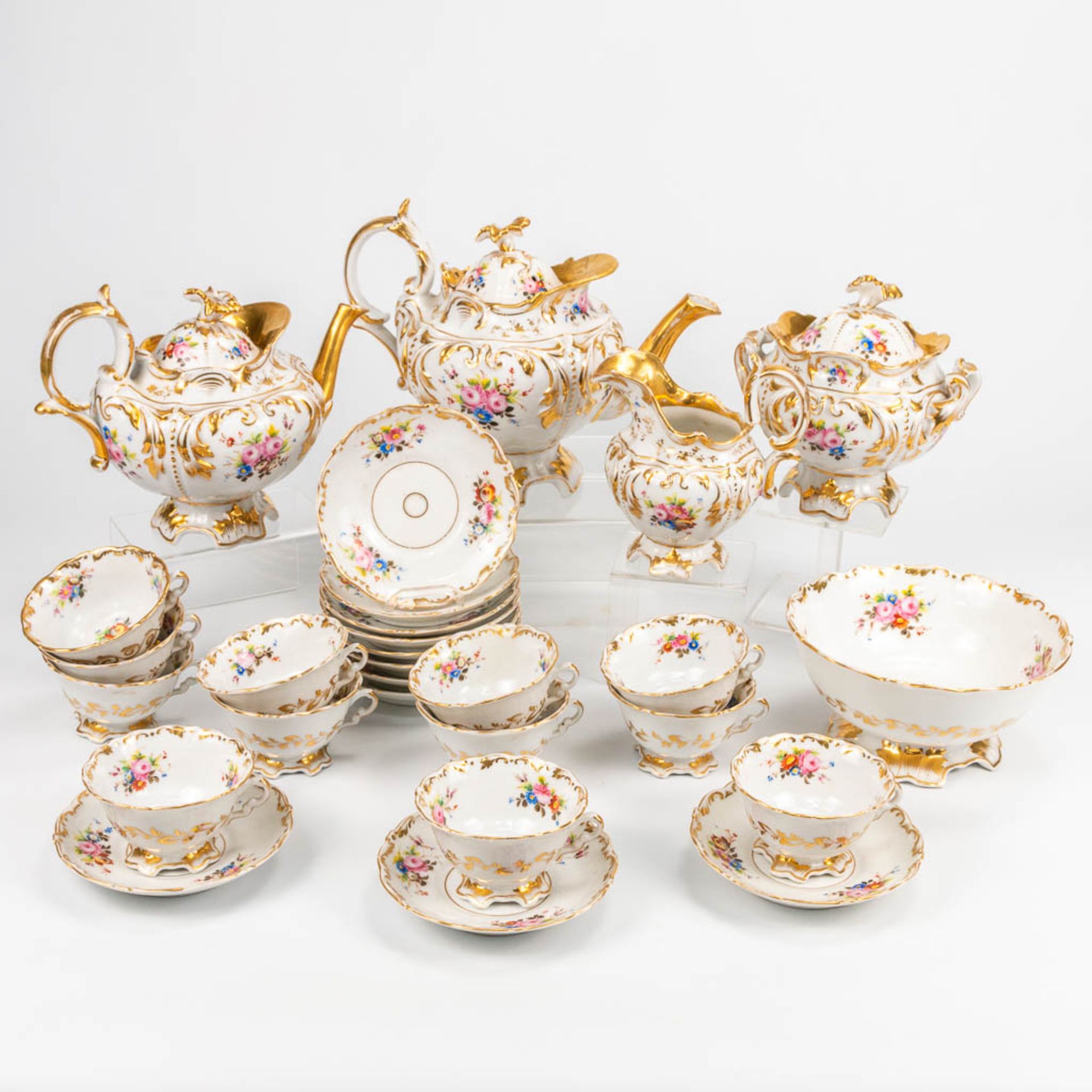 A coffee and tea service made of Vieux Bruxelles porcelain with hand painted flower decors. (20 x 28