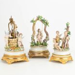 A collection of 3 porcelain statues of playing angels on a metal base, marked Capodimonte. (14 x 14