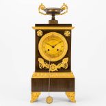 A table clock made in empire period of patinated and gilt bronze. 19th century. (10 x 19,5 x 46 cm)