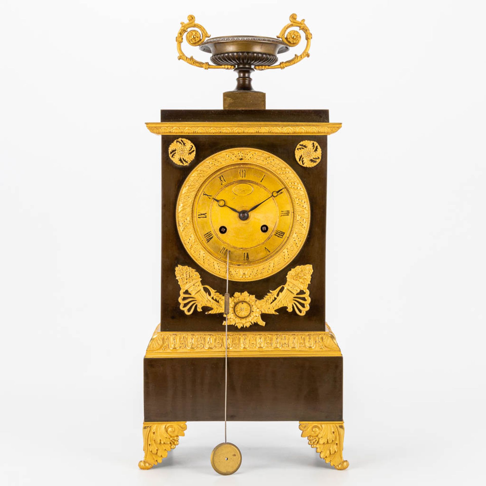 A table clock made in empire period of patinated and gilt bronze. 19th century. (10 x 19,5 x 46 cm)