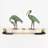 An art deco style statue of 2 ibis birds with a snail, made of spelter on an onyx and marble base. (