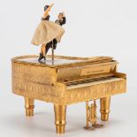 A music box of a piano made of metal with dancing couple. (11 x 9 x 12 cm)