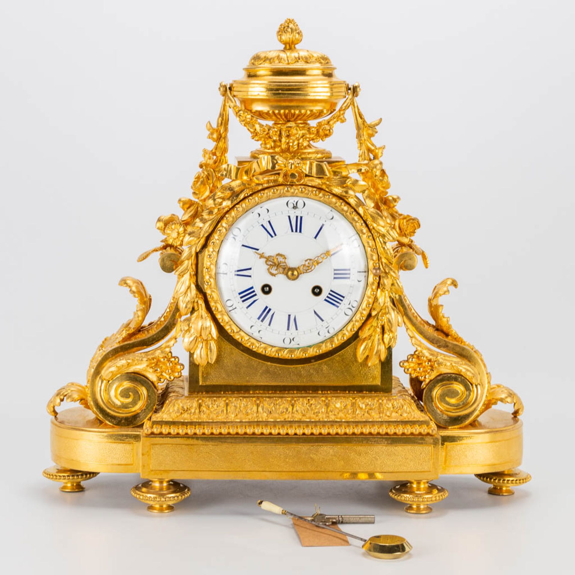 A bronze ormolu table clock made in Louis XVI style. 19th century. (15 x 41 x 42 cm)