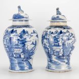 A pair of Chinese vases with blue-white decor and mountain landscapes. (46 x 28 cm)