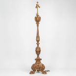 A large lamp base made of sculptured wood, standing on claw feet with sculptured children's faces. (