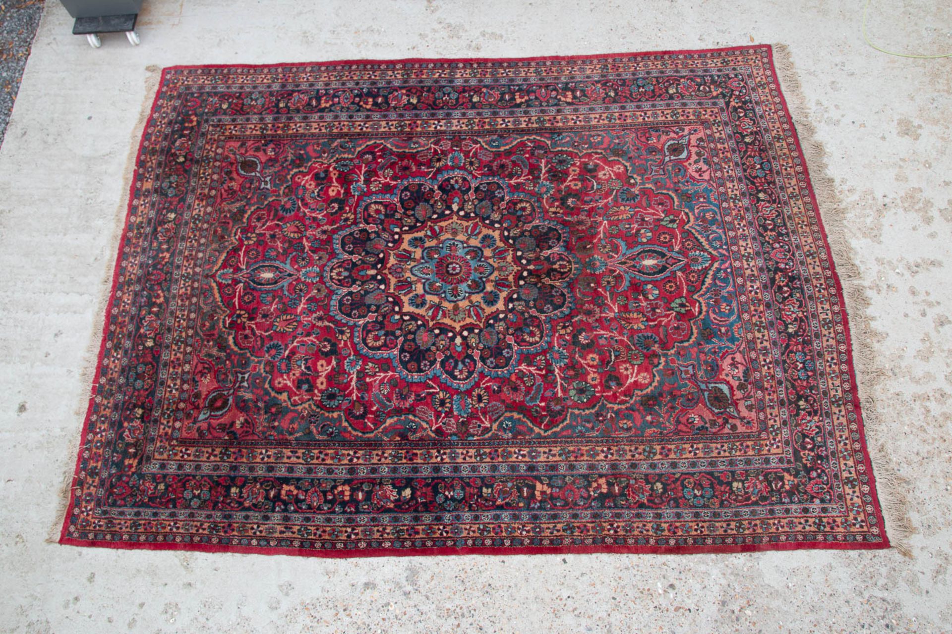 An Oriental hand-made carpet. Meshed. (342 x 255 cm)