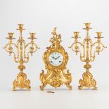 A 3 piece garniture clockset made of bronze, consisting of a clock and 2 candelabra. (9 x 22 x 41 cm