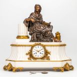 A mantle clock made of marble with a bronze statue of a nobleman. Neoclassical style. (25 x 62 x 61