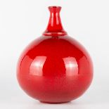 A vase made of red glazed white ceramics and probably made in Scandinavia. Period 1960-1970. (17 x 1