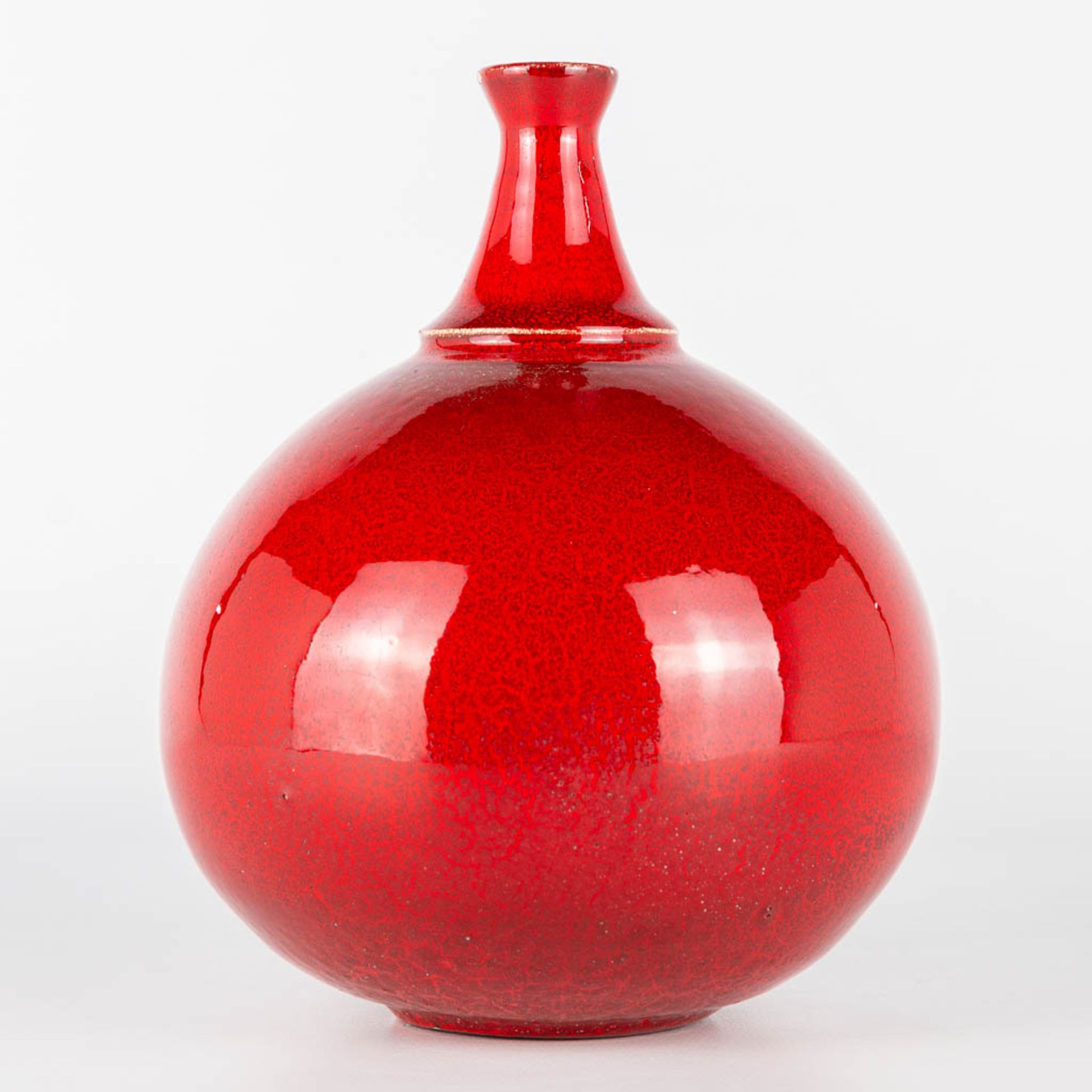 A vase made of red glazed white ceramics and probably made in Scandinavia. Period 1960-1970. (17 x 1