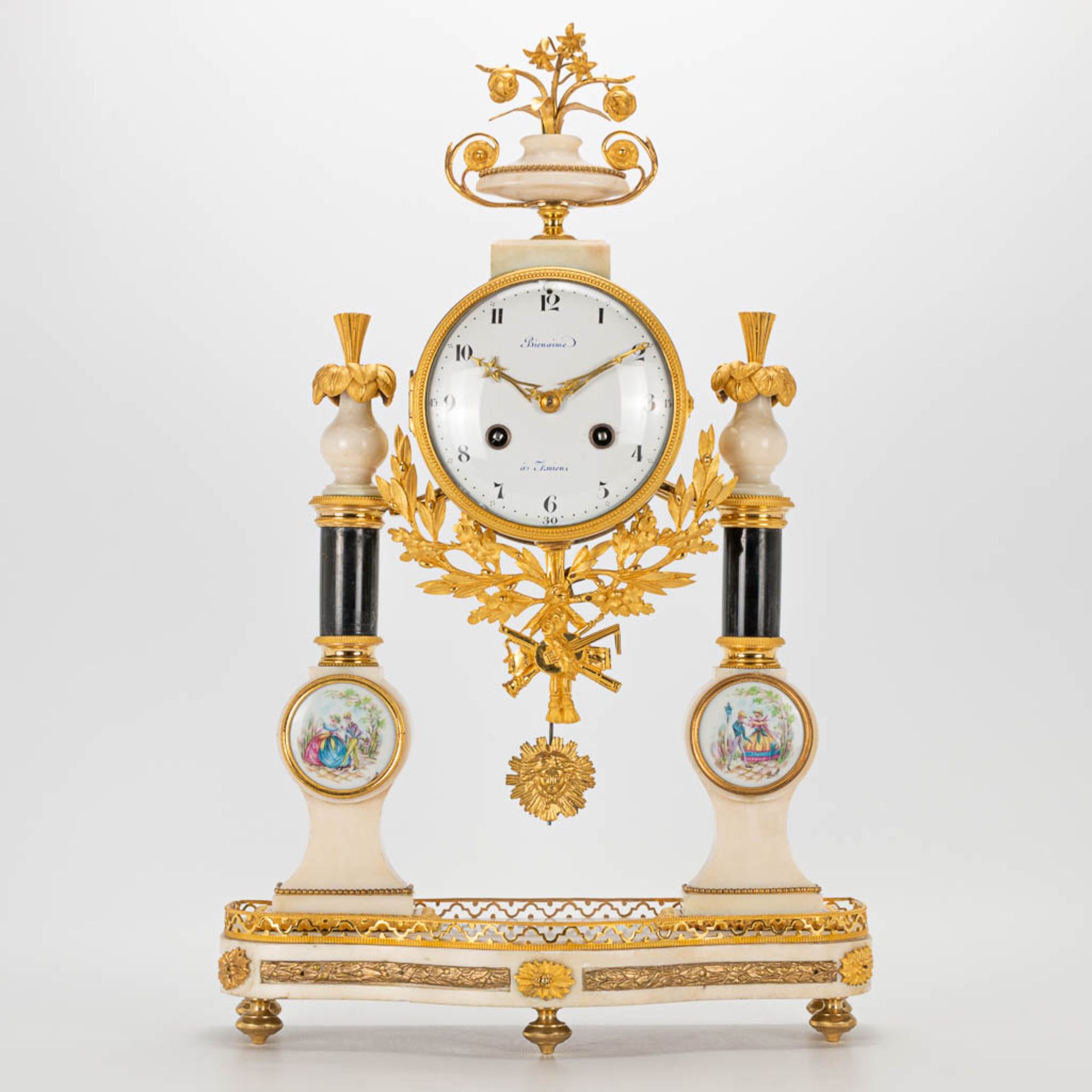 A Louis XVI style column clock made of bronze and marble, with handpainted Limoges plaques and marke