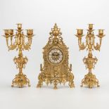 A 3 piece garniture clockset made of bronze, consisting of a clock and 2 candelabra. Battery operate