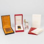 A collection of 2 Must De Cartier and 1 S.T. Dupont lighters. (3,7 x 6 cm)