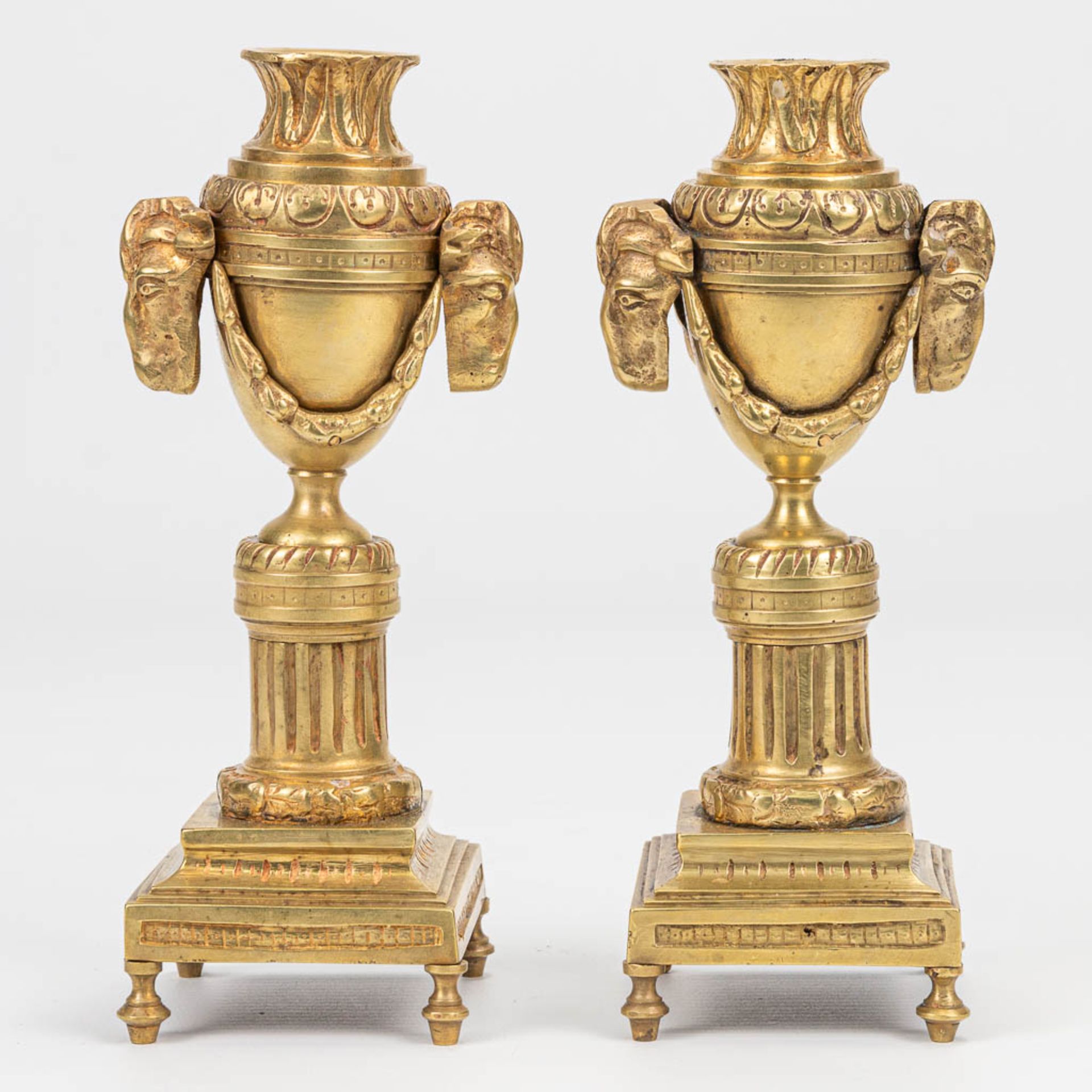 A pair of candlesticks with reversible candle holders and ram's heads in Louis XVI style. (7 x 8 x 1 - Image 2 of 8