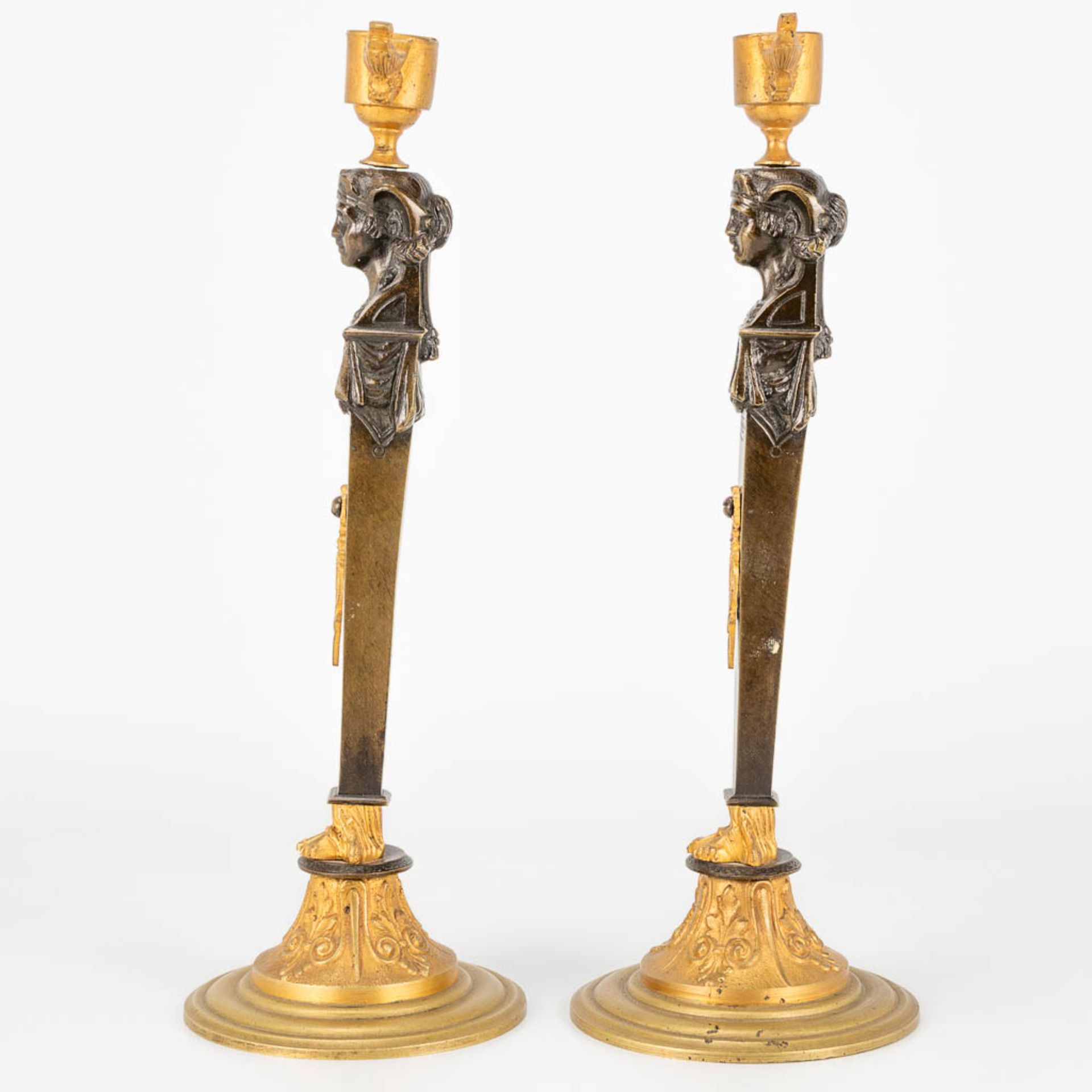 A pair of candlesticks made of gilt and patinated bronze in empire style. (27,5 x 9,5 cm) - Image 2 of 15
