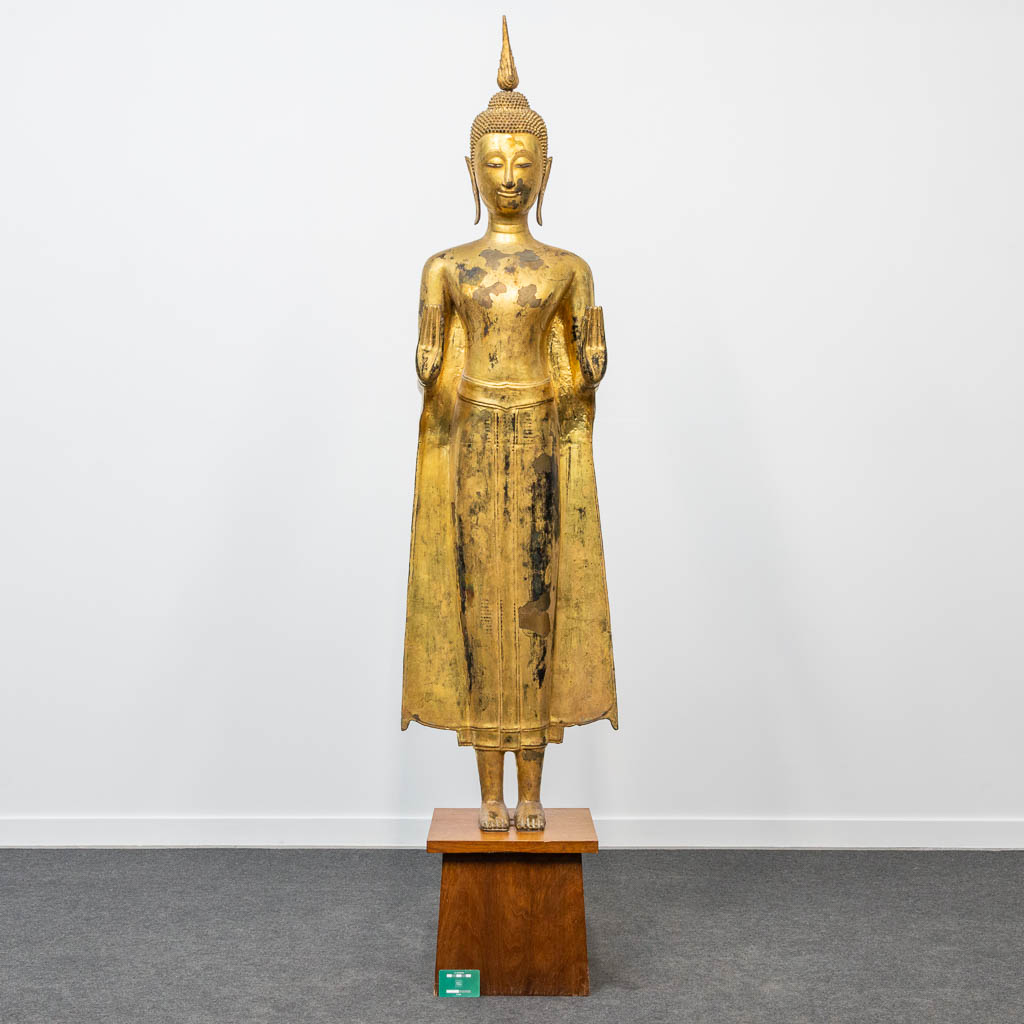 An antique buddha made of bronze and standing on a wood base. (28 x 48 x 180 cm) - Image 2 of 21