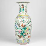 a large vase made of Chinese porcelain and decorated with roosters and flowers.
