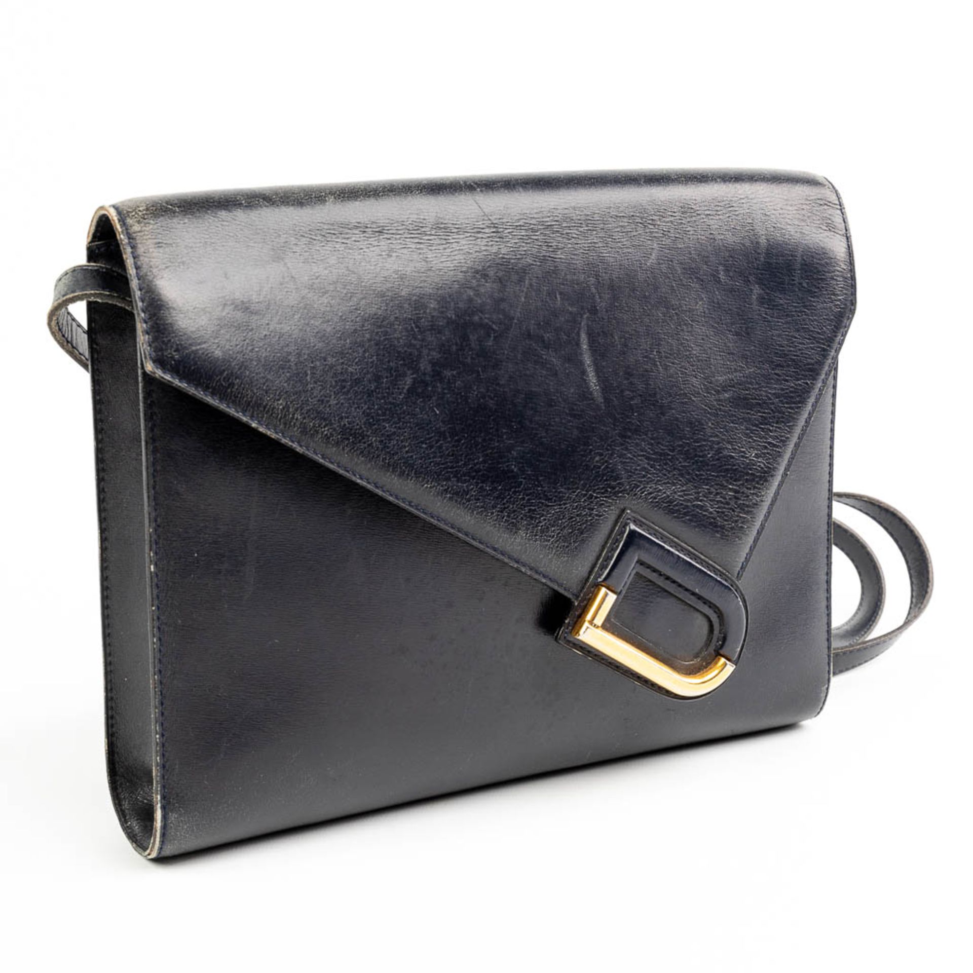 A purse made of black leather and marked Delvaux.
