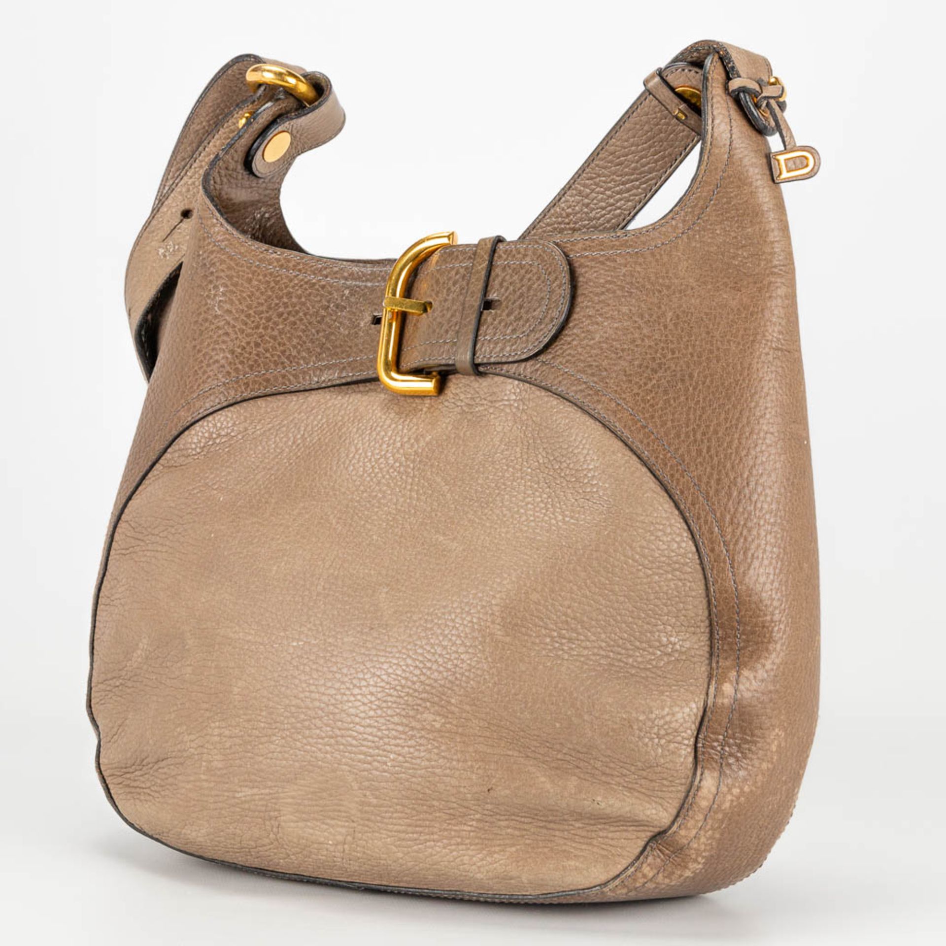 A purse made of brown leather and marked Delvaux.