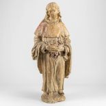 A statue made of stone with traces of the original polychrome paint. Probably 17th century.