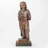 An antique wood sculpture of an evangelist, 17th century.