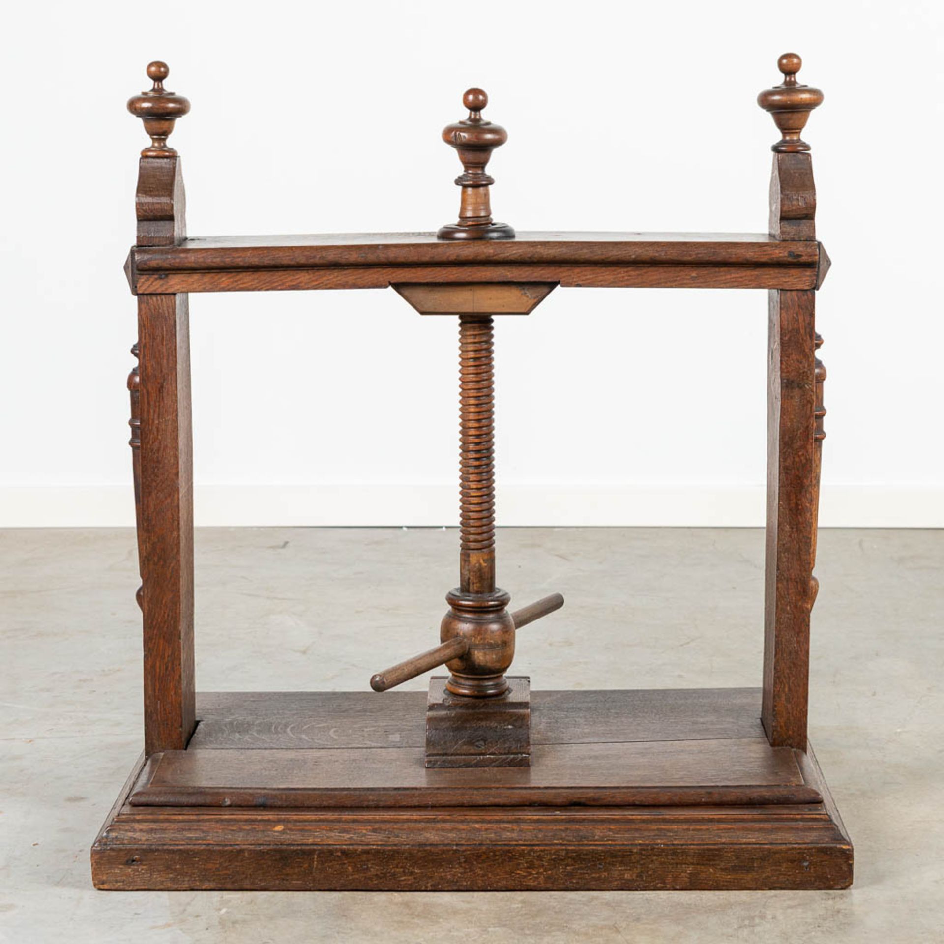 An antique linnen or book press, made of wood.
