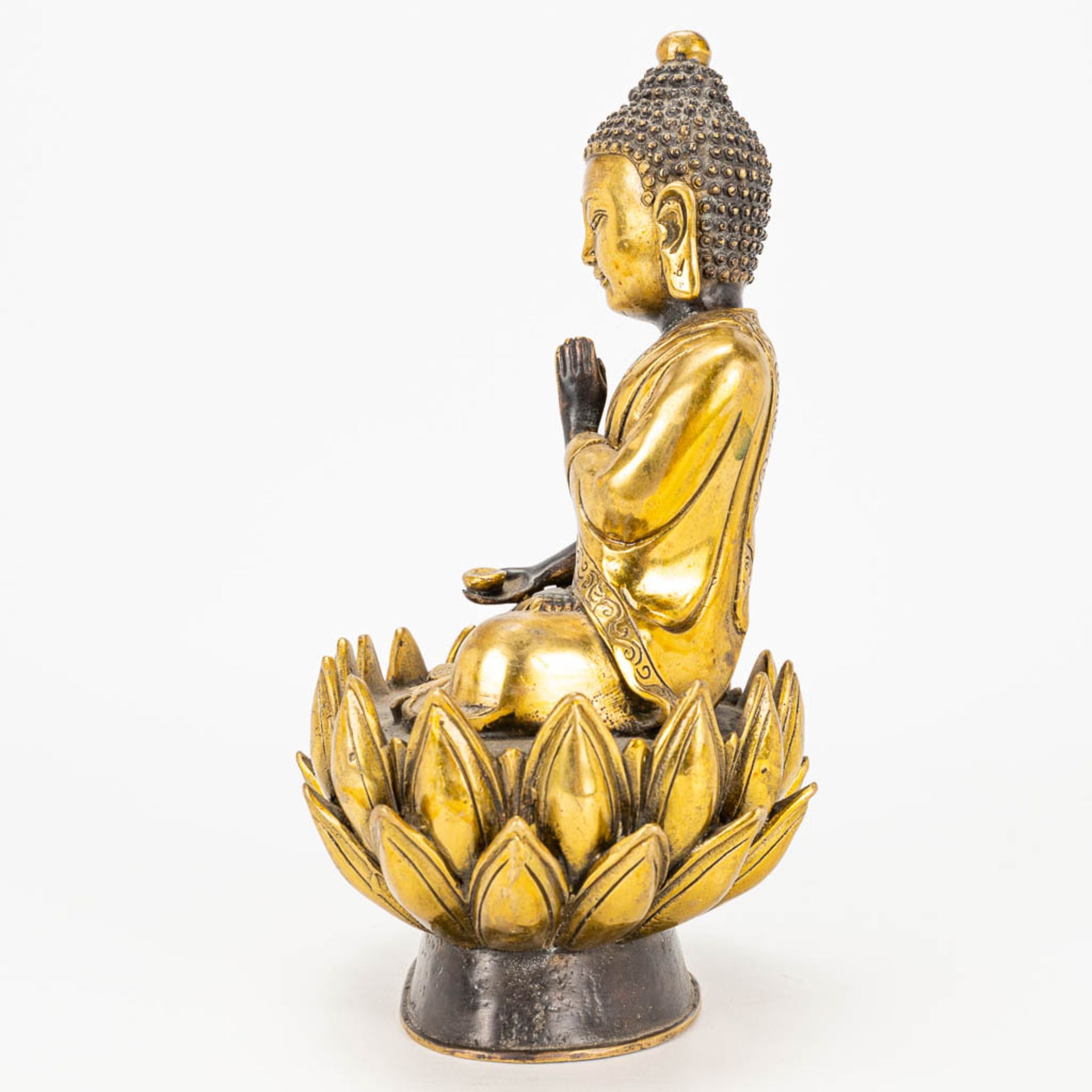 A Buddha on a lotus flower made of bronze. - Image 4 of 11