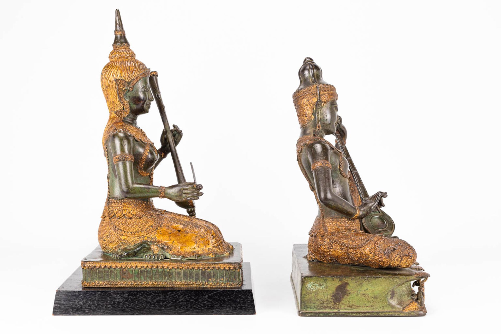 A collection of 2 oriental musical buddha's, made of metal. - Image 4 of 15