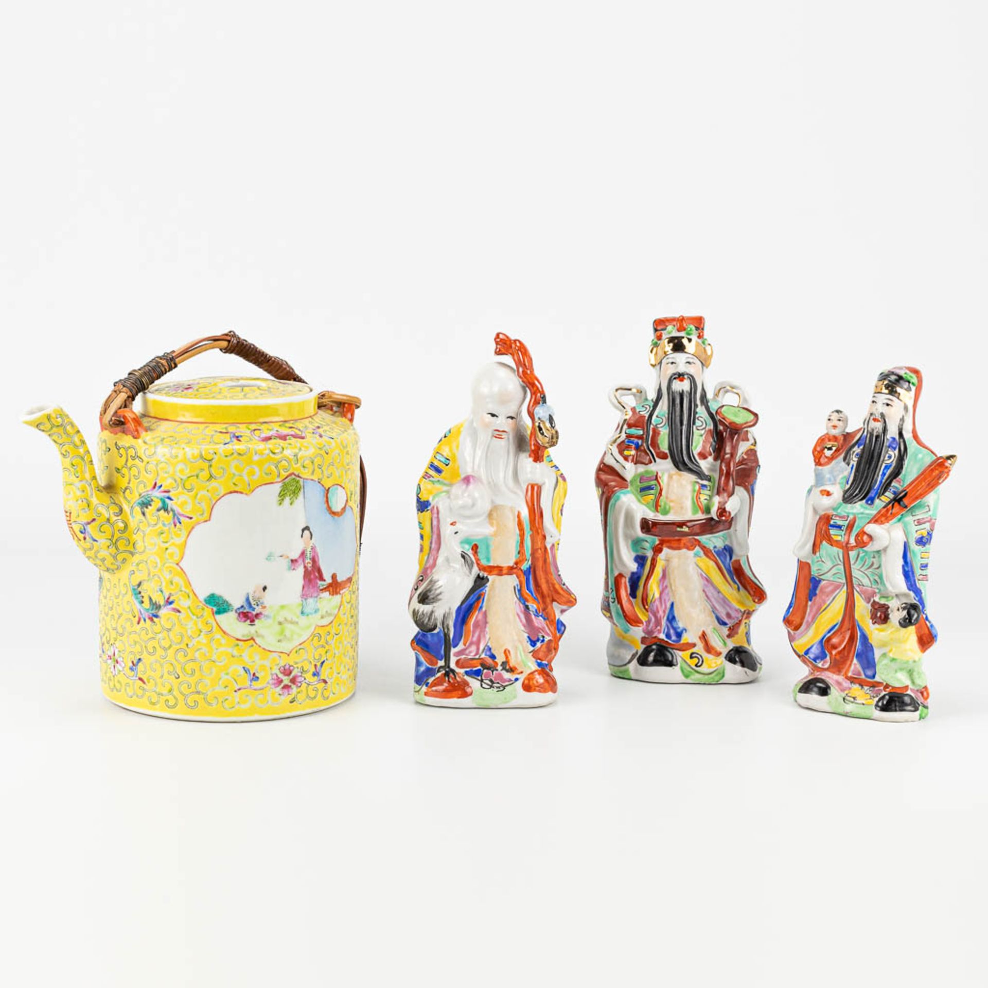 A collection of items made of Chinese porcelain, a teapot, and 3 wise men