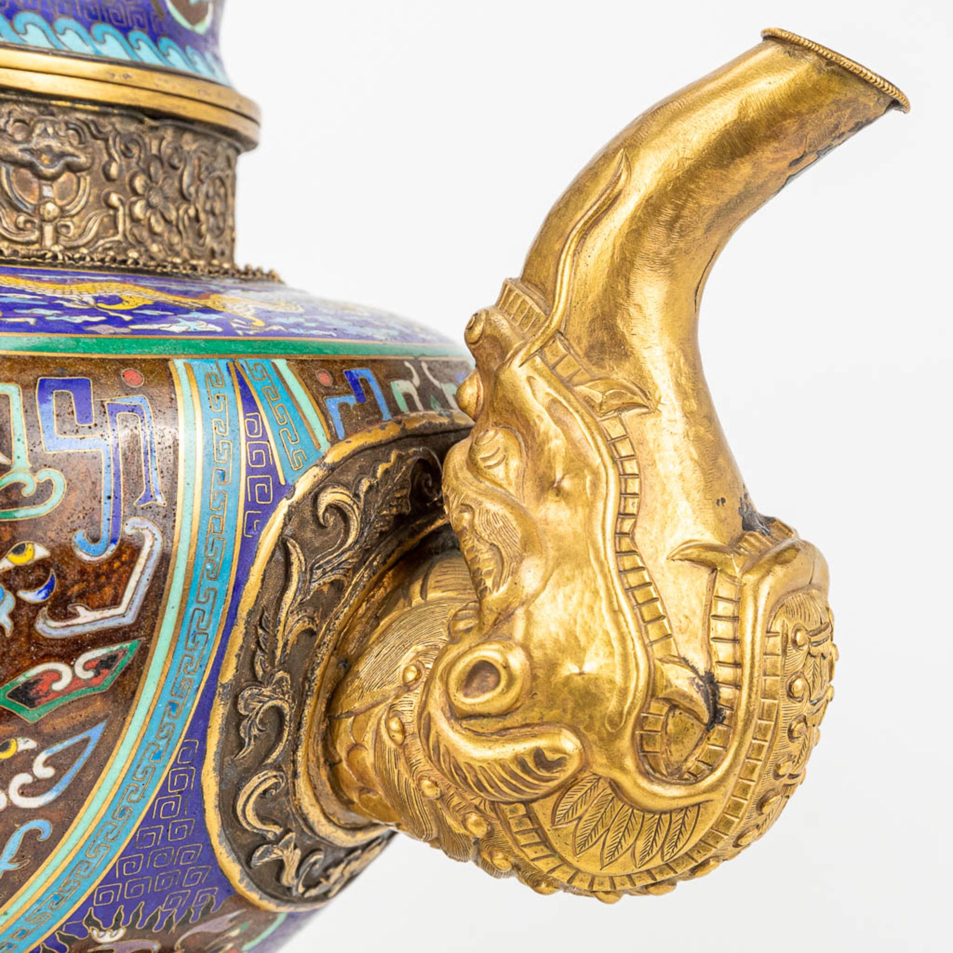 A Tibetan ceremonial ewer made of gilt bronze and finished with cloisonnŽ bronze. - Image 13 of 18