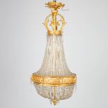 a large Sac-ˆ-Perles chandelier made of glass and bronze and decorated with ram's heads.