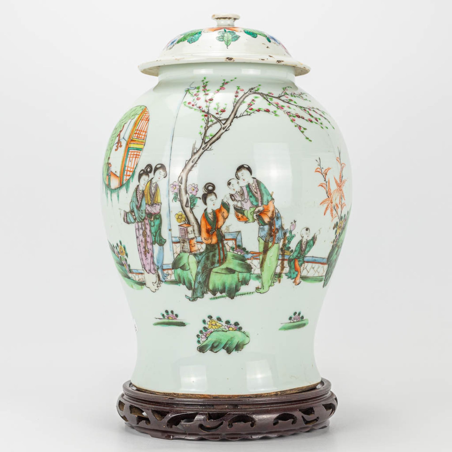 A vase with lid made of Chinese porcelain and decorated with ladies in the garden with a child