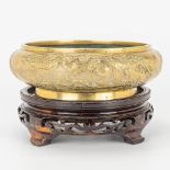 A bronze bržle parfum bowl, on a wood base. Marked Xuande.
