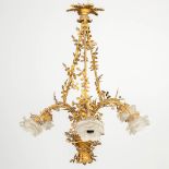 A chandelier in the shape of a flower basket, made of bronze with glass flower shades.
