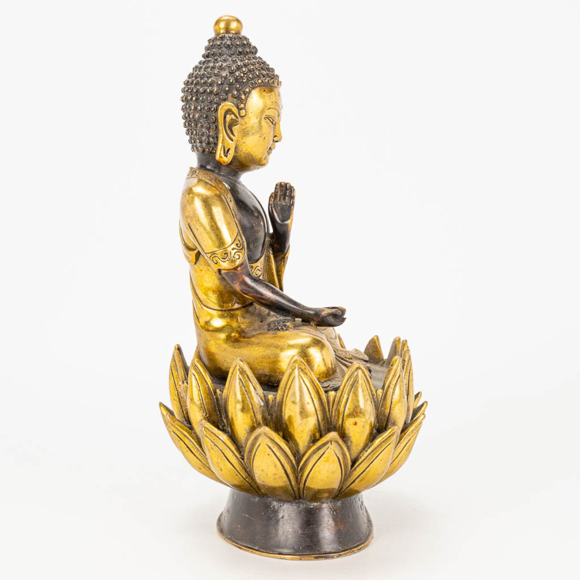 A Buddha on a lotus flower made of bronze. - Image 2 of 11