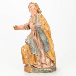 An antique wood sculpture of a man with traces of the original polychrome.