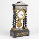 A column table clock with ebonized black wood and marquetry inlay in Napoleon 3 style.