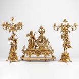 A three-piece mantle clock with candelabra, made of bronze standing on an onyx base.