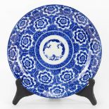 A large plate made of Japanese porcelain and decorated with blue-white lotus flowers.