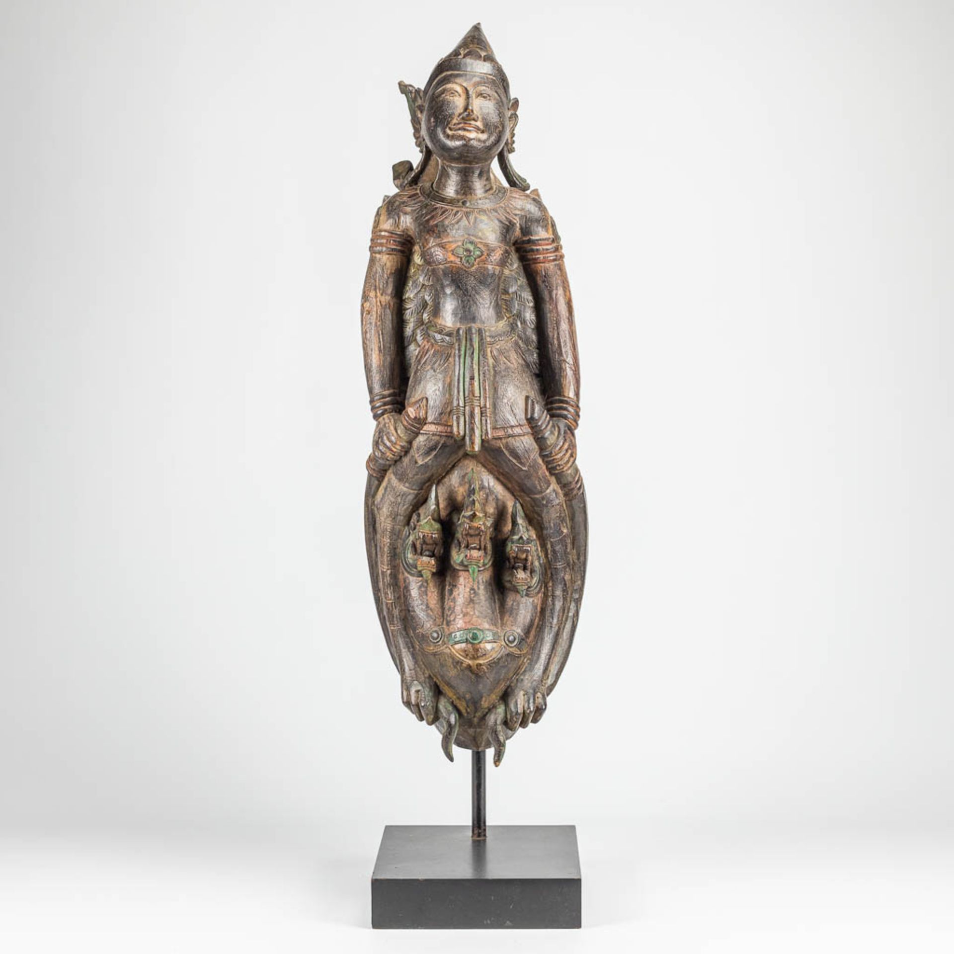 A large oriental sculptured statue of a mythological figurine.
