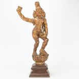 An antique wood sculptured figurine of Oriental origin, probably Indian.