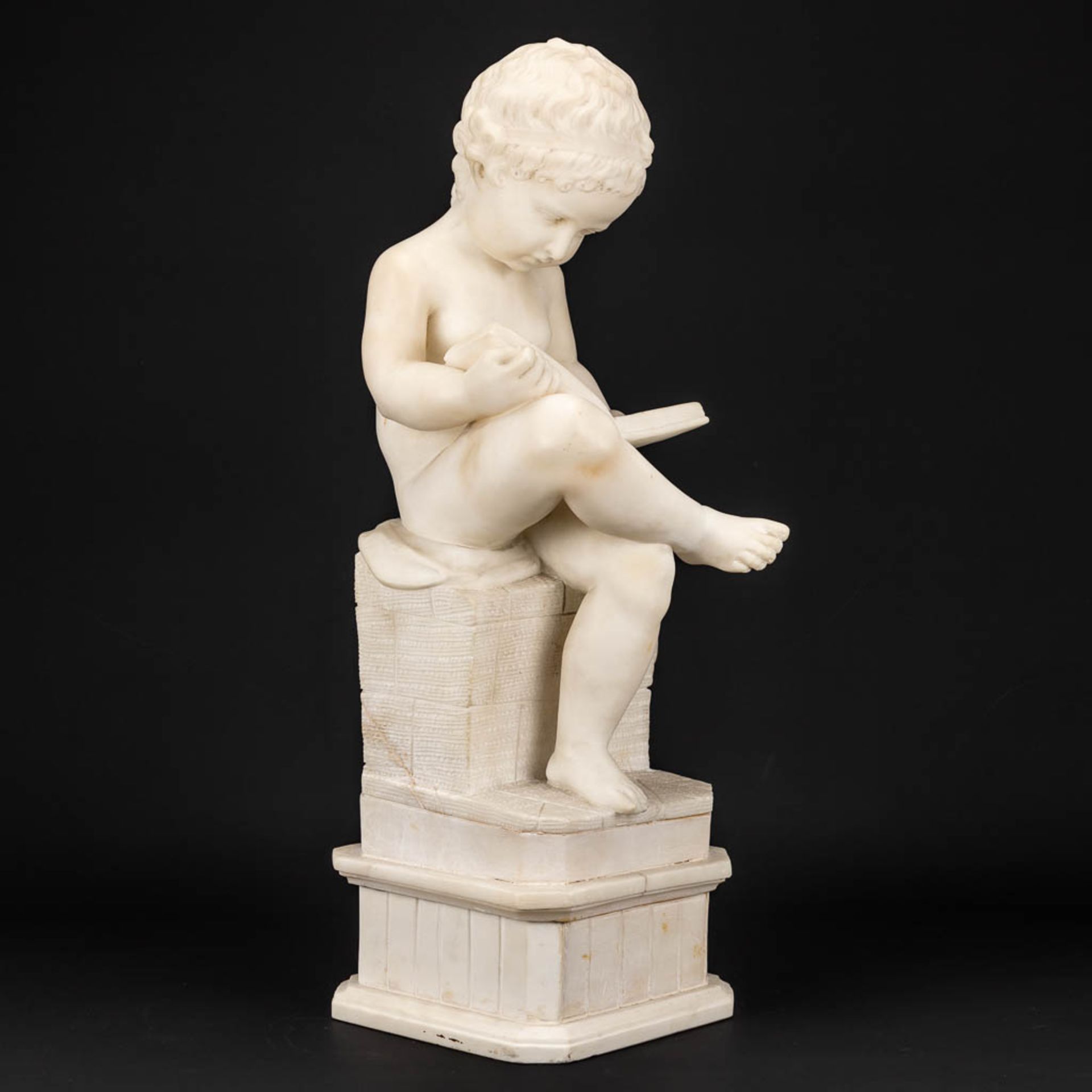 A statue of a reading boy made of alabaster. - Image 7 of 11