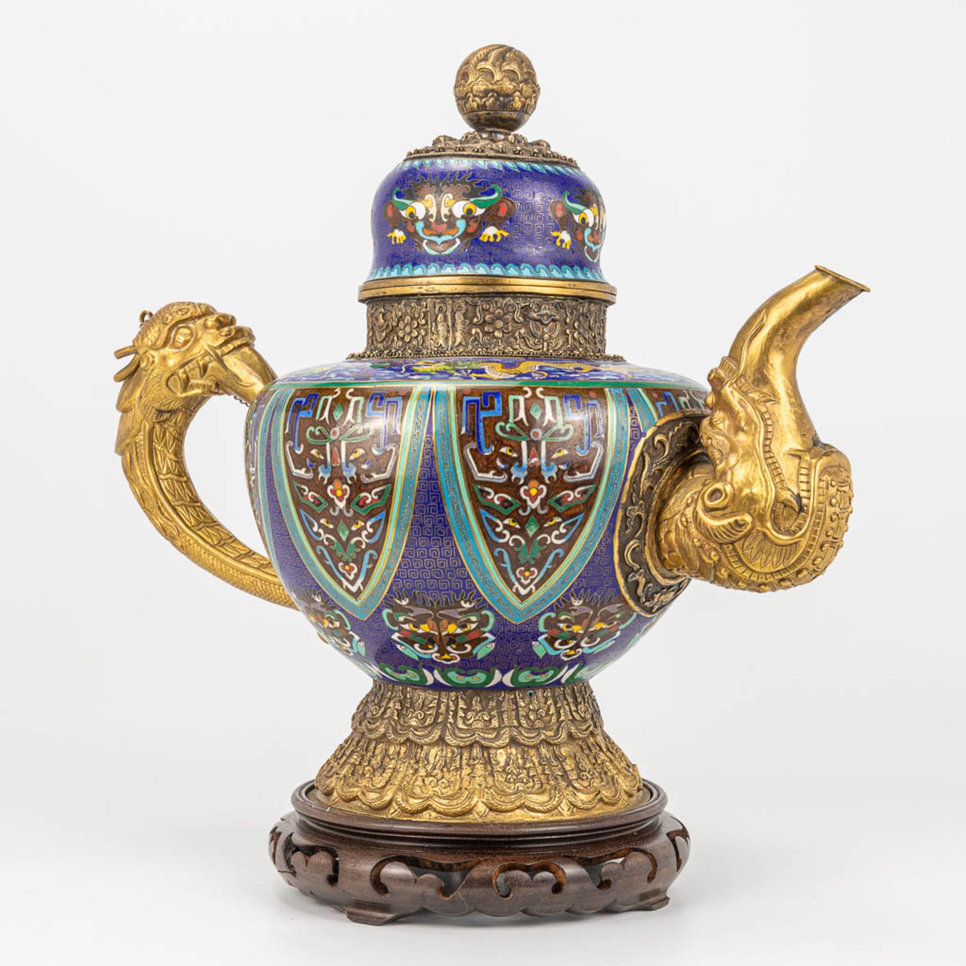 A Tibetan ceremonial ewer made of gilt bronze and finished with cloisonnŽ bronze. - Image 9 of 18