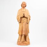 A large statue of a holy figurine of Jean-Marie Vianney (1786-1859) made of terracotta