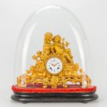 An ormolu gilt mantle clock, decorated with 2 putti under a glass dome. 19th century