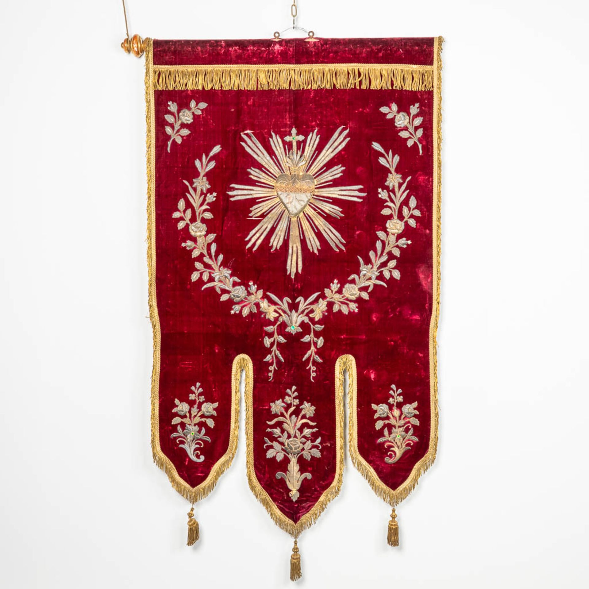 An embroidered banner with a 'Sacred Heart' image.
